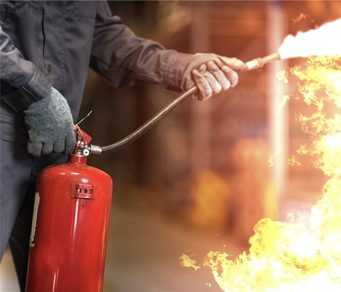 A person using a fire extinguisher. 