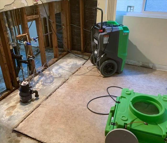 Green drying equipment in a room with flood cuts.