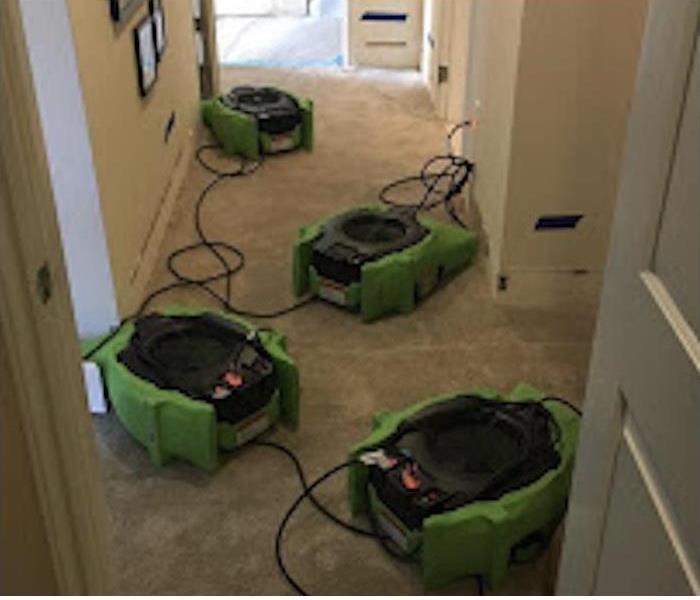 Restoration machines are cleaning a house after water damage
